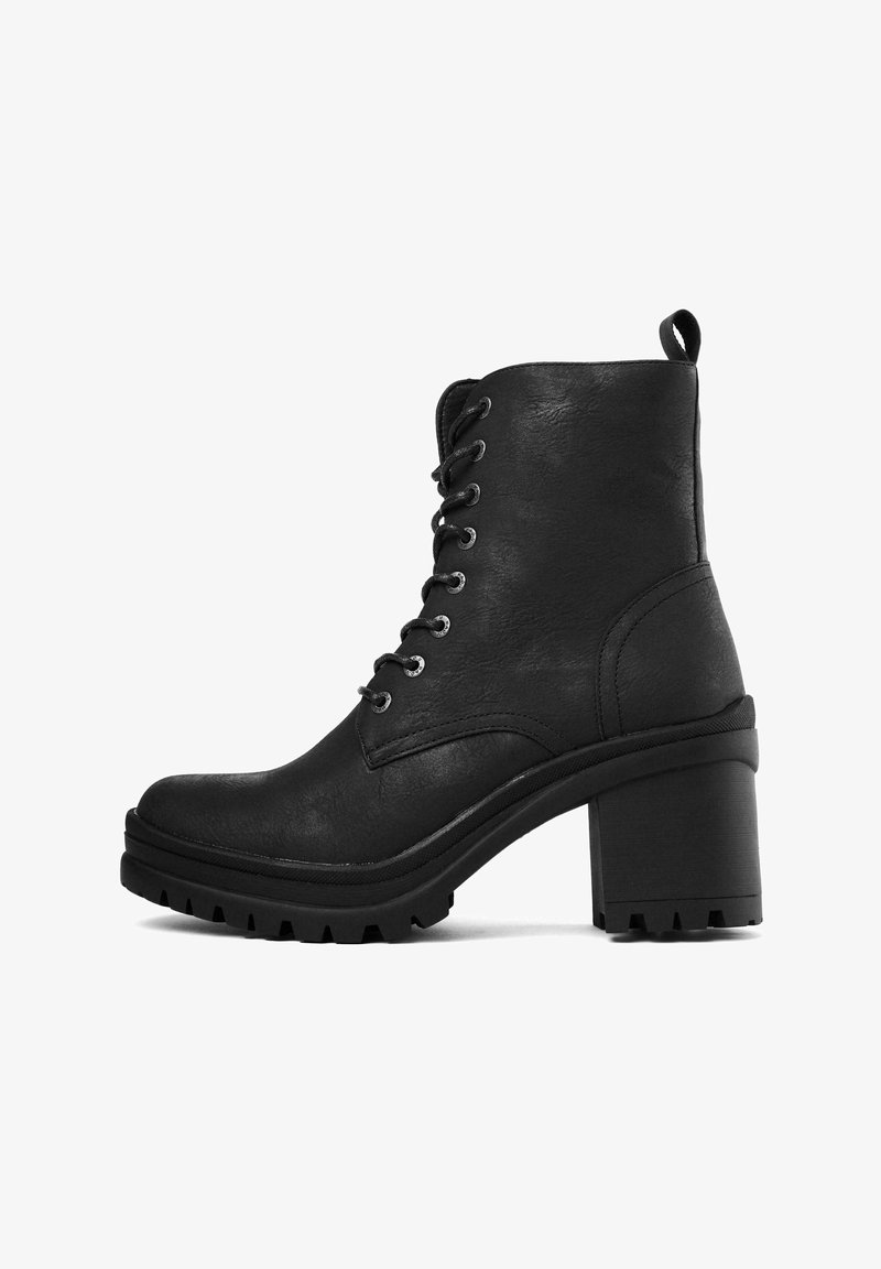 Black ankle boots in synthetic leather, featuring a high block heel, lace-up design, contrasting rubber sole with traction pattern, and looped pull tab.