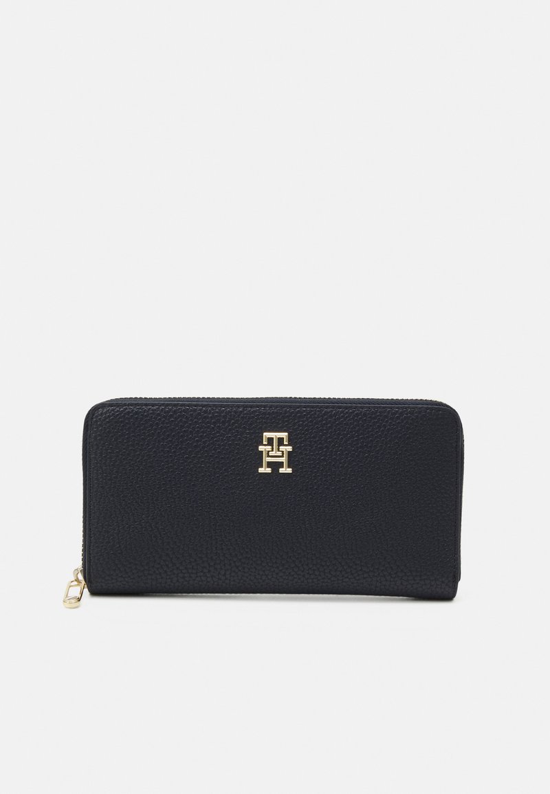 Black leather wallet with a textured finish, gold hardware, and a prominent embossed logo on the front. Zip closure at the top.