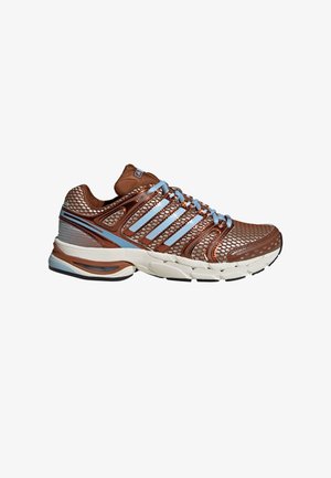 Brown athletic shoe with mesh upper, blue accents, and multiple stripes. Features a cushioned sole with a textured design. Rubber traction outsole.