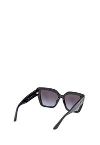 Black cat-eye sunglasses with gradient lenses, shiny plastic frame, and engraved logo on temples. Smooth surface with wide arms.