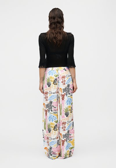 Μαύρο κοντό τοπ με εφαρμοστά μανίκια, συνδυασμένο με φαρδιά, χαλαρά παντελόνια σε πολλά χρώματα, με παιχνιδιάρικο σχέδιο από διάφορα μοτίβα και σχέδια.