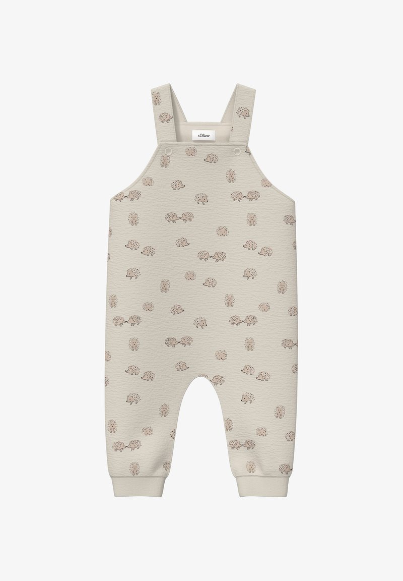 Béžové bavlnené overal s textúrovaným vzorom malých ježkov. Má nastaviteľné popruhy a elastické manžety na členkoch.