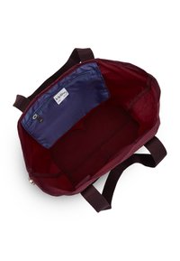 Maroon bag interior with a smooth texture, featuring a blue zippered pocket and a spacious main compartment. Dark fabric handles attached.