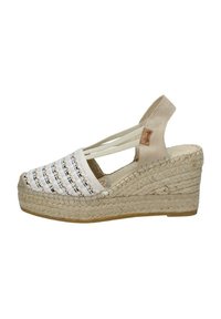 Sandalo a zeppa con tomaia in tessuto bianco intrecciato e dettagli neri, tacco in suede beige e suola intermedia avvolta in juta. Fascette elastiche regolabili.