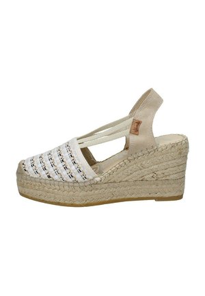 Sandalo a zeppa con tomaia in tessuto bianco intrecciato e dettagli neri, tacco in suede beige e suola intermedia avvolta in juta. Fascette elastiche regolabili.