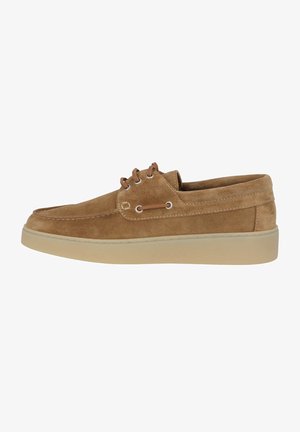Tan suede lace-up shoe with a rounded toe, contrasting light rubber sole, and two metal eyelets for laces. Smooth texture throughout.
