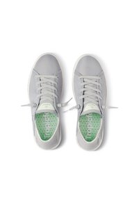 Gray athletic shoes with a mesh upper, flat laces, and a perforated green insole featuring the word "Tropic." Rubber sole and rounded toe.