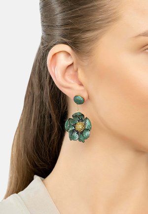 Green floral earrings featuring textured petals, a gold center detail, and a round stud post. Crafted from a sparkling material.