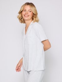 Light grey pajama set featuring a collared short-sleeve top with buttons and a chest pocket, and matching elastic-waist pants with a textured stripe pattern.