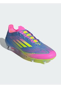 Bright blue and pink soccer cleat with yellow accents. Features a textured surface, lace-up design, and translucent studs for traction.