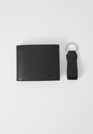Black leather wallet with a sleek design, featuring stitched edges and embossed logo. Accompanied by a matching black keyring.