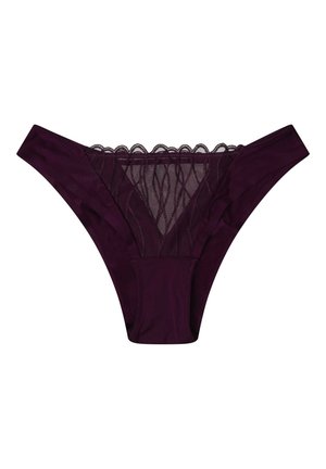 Lila Stringtanga mit transparentem Spitzenpaneel in Wellenmuster. Glattes Material und gewellte Kanten am Taillenbund sowie vorne.