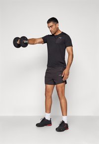 Puma FLEX TEE - Sports T-shirts - black
