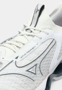 White running shoe with grey accents, textured upper, visible lacing system, and "WAVE PROPHECY 14" branding on the side.