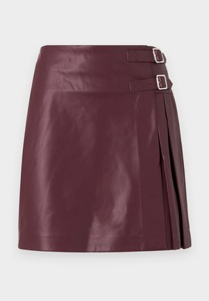 Burgundy leather mini skirt with pleats at the side and two silver buckle accents. Smooth texture with a glossy finish.