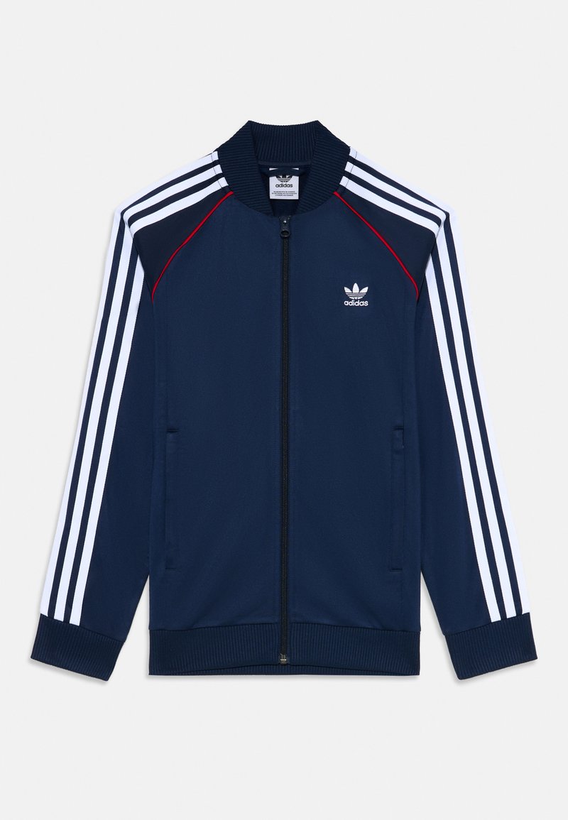 Jūras spēku zip-up treniņjakas ar ribotām apkaklēm un aprocēm, baltu trīs joslu dizainu uz piedurknēm, ar mazu baltu Adidas logo uz krūtīm.