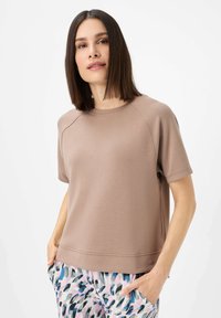 Hellbraunes Sweatshirt mit kurzen Ärmeln und rundem Ausschnitt, ausgestattet mit Raglanärmeln, lockerem Schnitt und kleinem Logodetail am Saum.