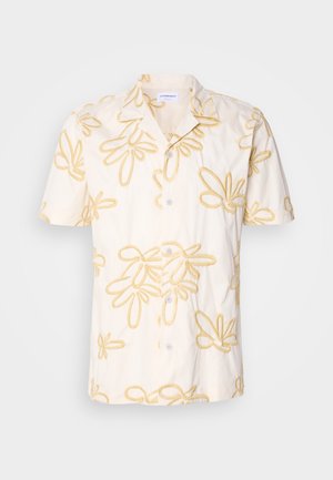 Lühikeste varrukatega särg, millel on kreemikas kangas kollaste lillemustritega ning nööpidega ees ja klassikaline kaelus.