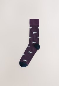 Chaussette violette foncée avec motifs de rhinocéros bleu clair, talon et pointe bleu marine contrastants, texture lisse et bord-côte côtelé. Design classique longueur crew.