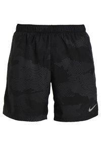 Svarta sportshorts med en texturerad, mönstrad yta. Har en elastisk midja och en liten grå Nike swoosh-logotyp.