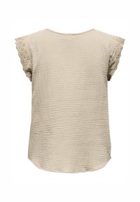 Haut beige avec un tissu tissé texturé, des manches en dentelle festonnée et un ourlet arrondi. La vue de dos met en avant la simplicité du design.