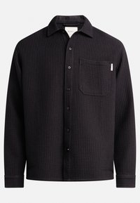 Black long-sleeve shirt with a textured waffle pattern, button closure, collar, and single chest pocket accent. Flat hem and cuffed sleeves.