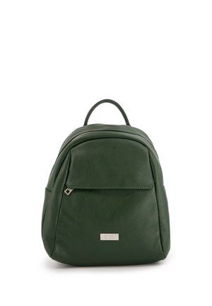 Green leather backpack with a textured finish, rounded shape, top handle, and front zipper pocket. Features a metallic logo on the front.