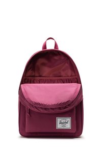 Sac à dos Herschel en tissu bordeaux, présentant un extérieur lisse, un grand rabat et un intérieur doublé avec une poche élastique pour l'organisation.