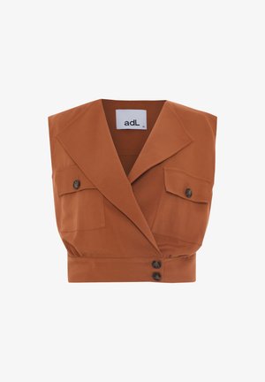 Cropped rust-colored top with a lapel collar, two front pockets, and three buttons. Made of smooth fabric with a tailored design.