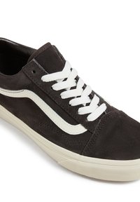 Brown suede sneaker with white laces, featuring a white wave design on the side and a light-colored rubber sole.