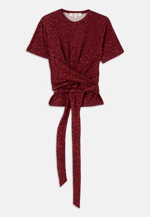 Red leopard print T-shirt with a rounded neckline, short sleeves, and a knotted waist detail; made from soft, textured fabric.