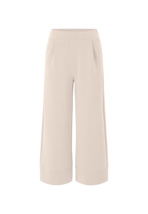 Pantalons larges beige avec une texture lisse, une taille élastique et deux poches latérales. Les poignets sont retournés pour un détail supplémentaire.