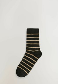Black sock with beige horizontal stripes, ribbed texture, and a solid toe and heel, laid flat on a light background.