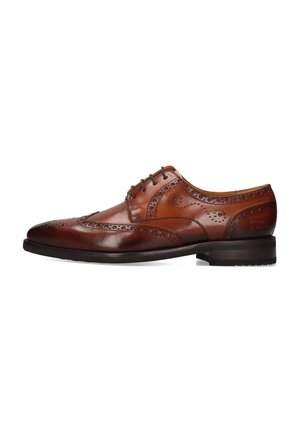 Brown leather dress shoe with brogue detailing, rounded toe, and medium heel. Features intricate perforations and a smooth finish.