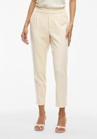 Beige op maat gemaakte broek met een soepele textuur, slim-fit ontwerp en enkel lengte. Voorzien van voorplooien en een platte tailleband.