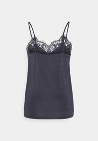 Navycamisole dengan tali tipis, menampilkan hiasan renda hitam transparan di leher dan badan kain yang halus serta sedikit berbahan tekstur.