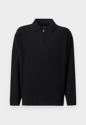 Crna polo majica dugih rukava s patentnim zatvaračem na ovratniku. Rebrasti uzorak, ležerni kroj, bez vidljivih logotipa ili uzoraka.