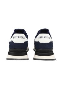 Navy suede and white leather sneakers with black sole; features logo on heel and distinctive design with contrasting accents.