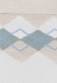 Knit sweater featuring a geometric pattern with beige, light green, and blue diamonds on a cream background, soft texture, and medium thickness.