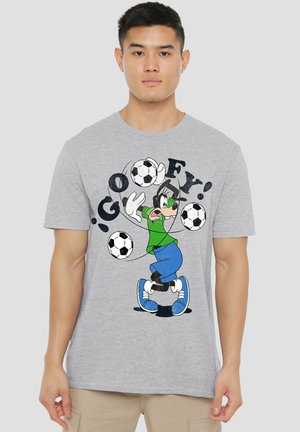 Man wearing gray t-shirt with cartoon dog juggling three soccer balls and the word "GOOFY!" in black letters.