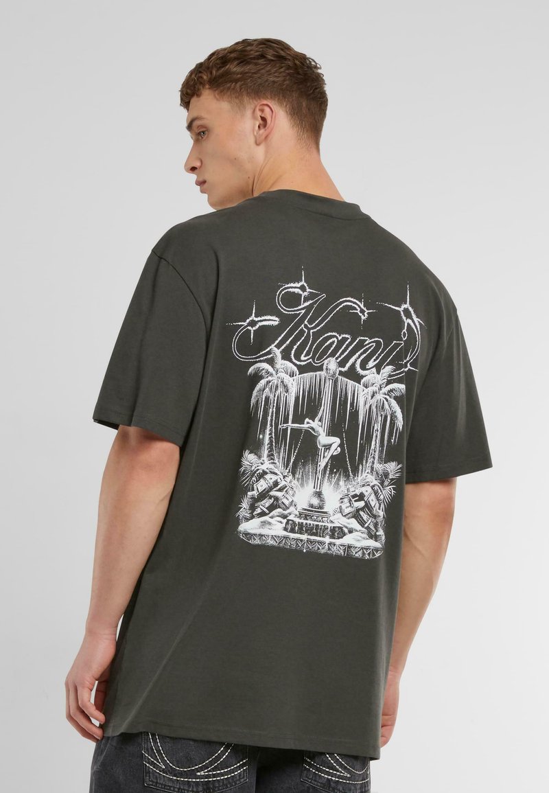Dark green cotton t-shirt featuring a large white graphic print on the back with palm trees, a fountain, and stylized text.