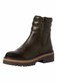 Bottine en cuir vert foncé avec des détails rembourrés sur les côtés, une fermeture éclair sur le côté et une épaisse semelle en caoutchouc brun avec un motif texturé.