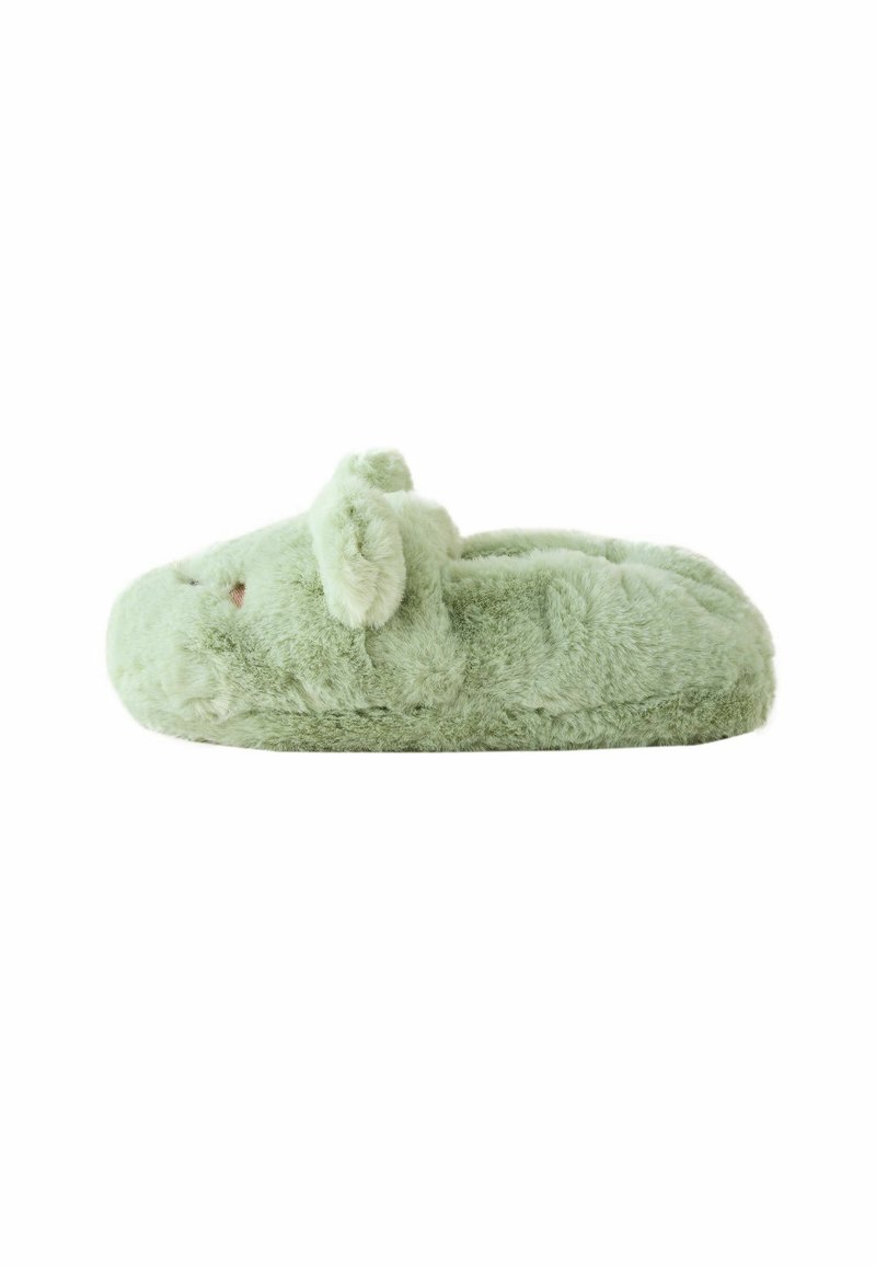 Zapatilla de felpa verde con forma redondeada, textura suave y pequeñas orejas en la parte delantera, diseñada para brindar comodidad y calidez.