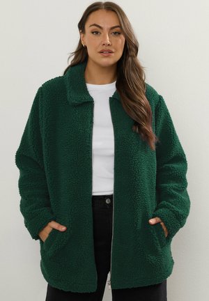 Grüne Fleecejacke mit kragen, Fronttaschen und einem Reißverschluss. Weicher Stoff, entspannte Passform und lange Ärmel.