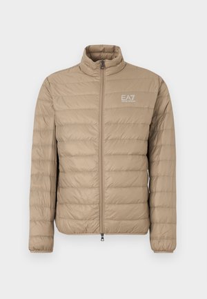 Bėgių spalvos pūsta striukė su aukštu apykakliu, vertikaliu siuvimu, užtrauktuko uždarymu ir mažu EA7 logotipu kairėje krūtinės pusėje. Lygus paviršius.