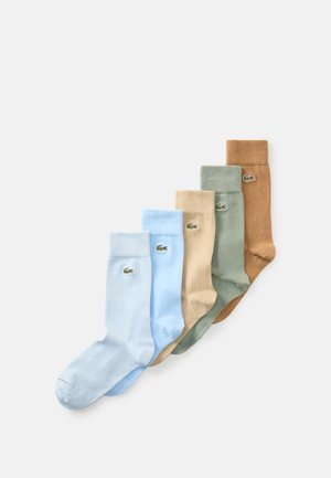 Five pairs of cotton socks in light blue, beige, green, and brown, featuring a small Lacoste logo on the side, with ribbed cuffs.