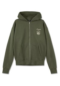 Olivezöld, cipzáras kapucnis pulcsi puha anyagból, elülső logónyomattal és két oldalsó zsebbel. A bordás mandzsetta és az alja textúrát ad.