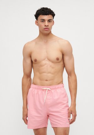 Shorts de bain roses en tissu léger, dotés d'une taille élastique avec cordon de serrage et d'un petit logo dans l'ourlet inférieur.