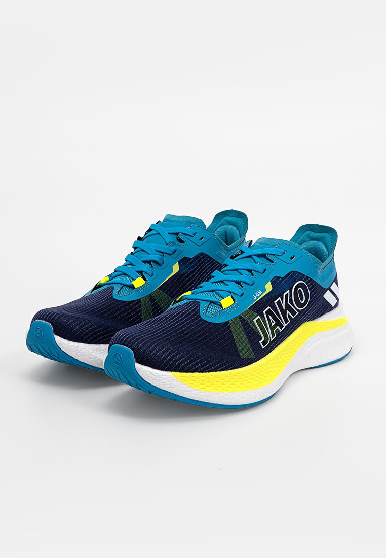 Un par de zapatillas de correr JAKO en azul y amarillo con suelas, cordones y textura de malla blancos, colocadas en ángulo sobre un fondo blanco.