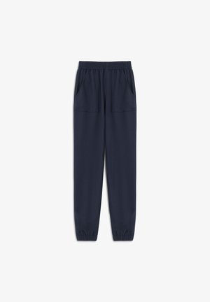 Pantalons de jogging bleu marine en tissu doux, dotés d'une taille élastique, de deux poches avant et d'ouvertures de jambes fuselées avec des poignets élastiques.